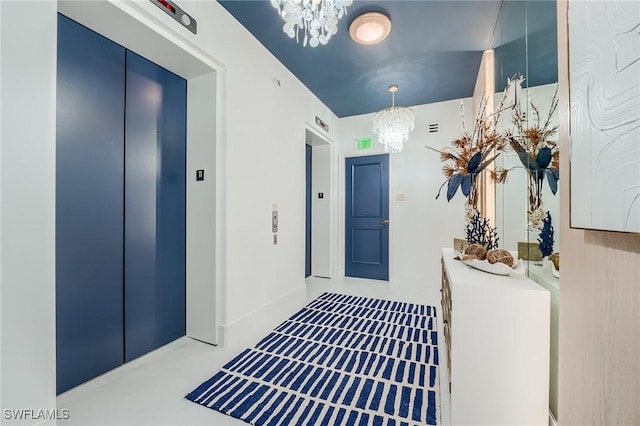 interior space with a notable chandelier and elevator