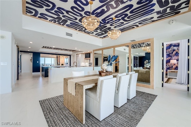 dining room featuring an inviting chandelier and a tray ceiling