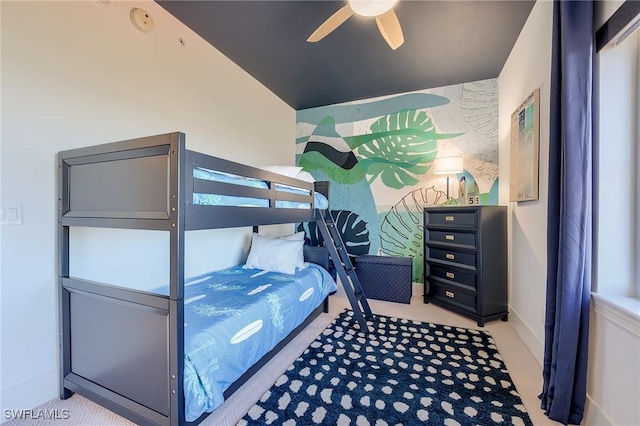 carpeted bedroom featuring ceiling fan and lofted ceiling