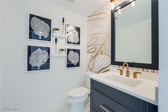 bathroom featuring vanity and toilet