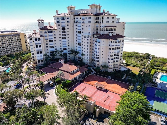 birds eye view of property with a beach view and a water view