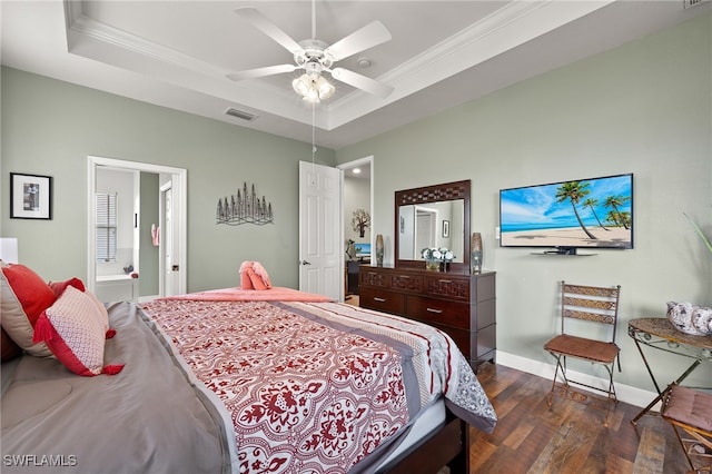 bedroom with ensuite bathroom, ornamental molding, a raised ceiling, ceiling fan, and dark hardwood / wood-style floors