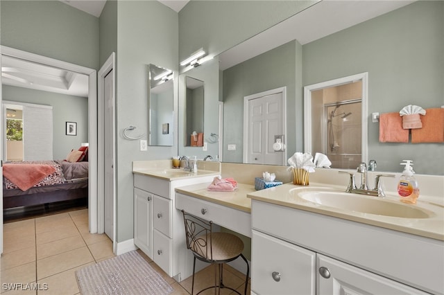 bathroom with tile patterned flooring, vanity, and walk in shower