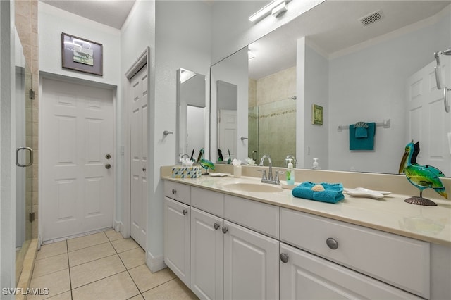 bathroom with tile patterned floors, vanity, an enclosed shower, and ornamental molding