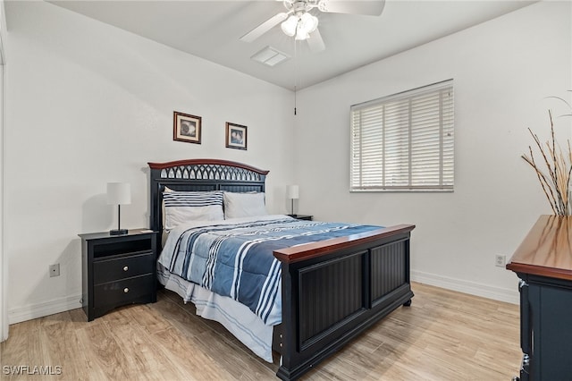 bedroom with light wood-style floors, baseboards, and a ceiling fan