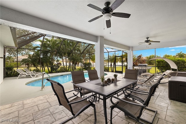 view of patio / terrace featuring glass enclosure and ceiling fan