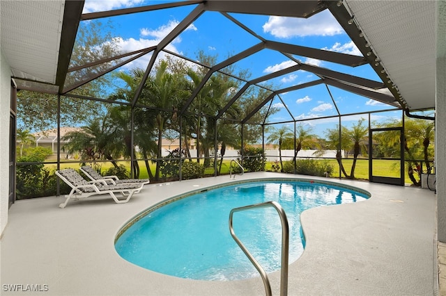 view of pool with a lanai and a patio