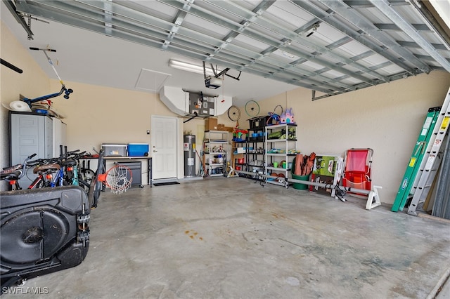 garage with a garage door opener and water heater