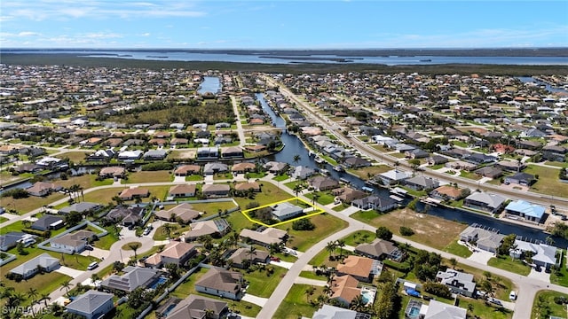 birds eye view of property featuring a water view and a residential view