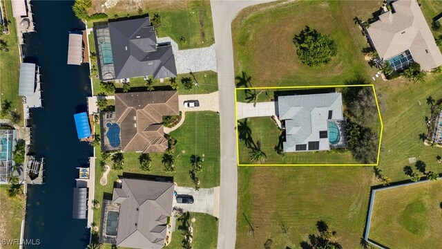 birds eye view of property with a residential view and a water view