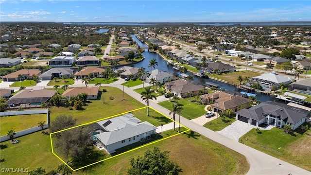 bird's eye view with a water view and a residential view