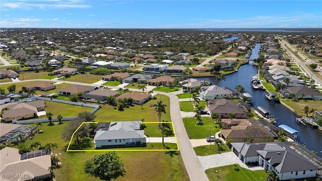 bird's eye view featuring a water view and a residential view