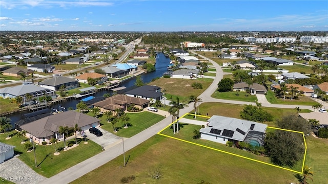 drone / aerial view with a residential view and a water view