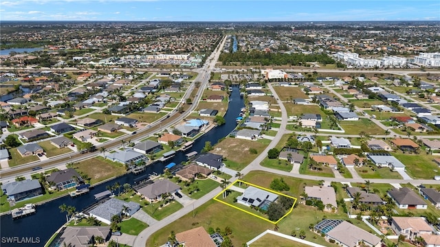 drone / aerial view featuring a water view and a residential view