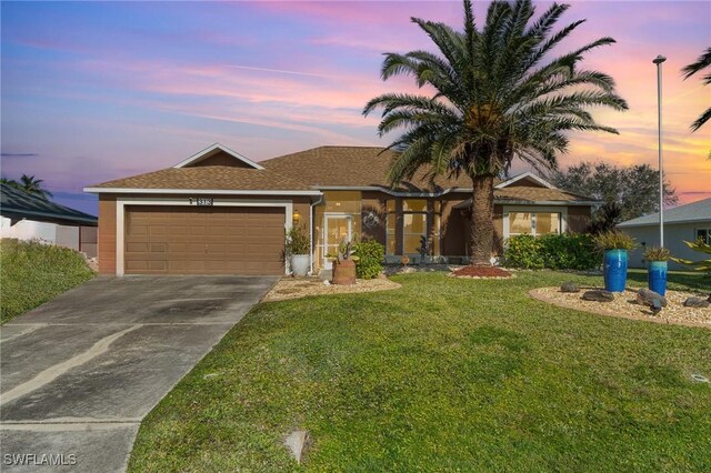 ranch-style house featuring an attached garage, a lawn, and concrete driveway