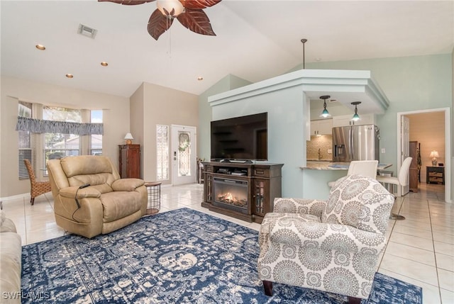 living room featuring light tile patterned floors, ceiling fan, and lofted ceiling