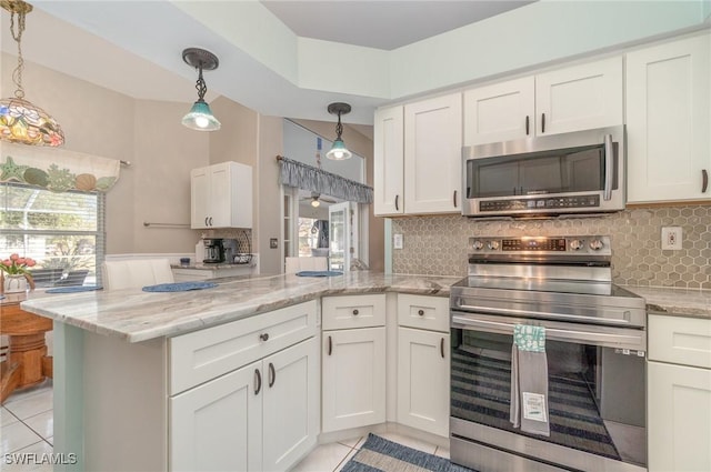 kitchen featuring kitchen peninsula, stainless steel appliances, white cabinetry, and light tile patterned flooring