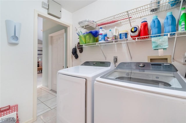 clothes washing area featuring light tile patterned flooring and washing machine and clothes dryer