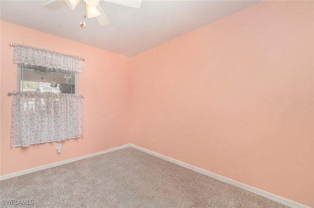 spare room featuring carpet, baseboards, and ceiling fan