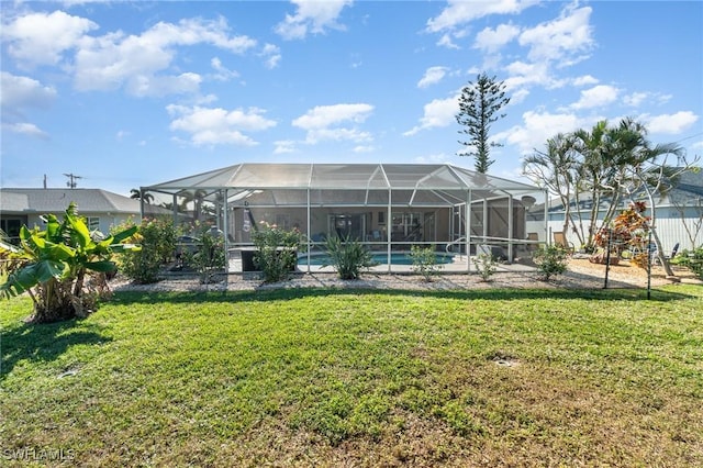 back of property featuring a lawn, a lanai, and an outdoor pool