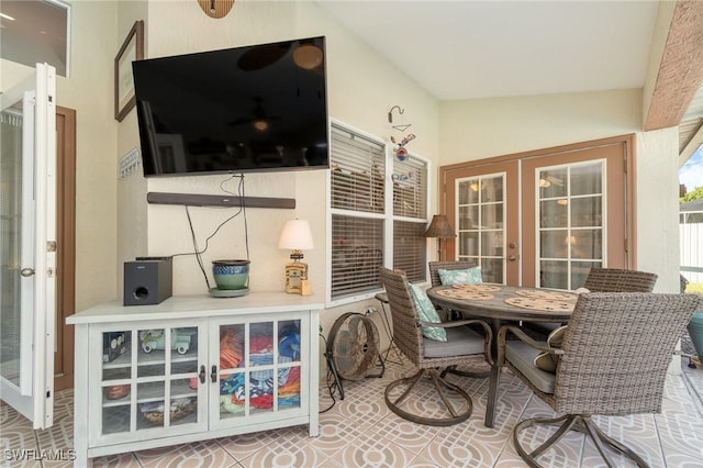 sunroom featuring vaulted ceiling and french doors