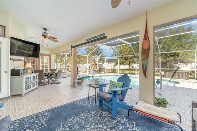 view of patio / terrace featuring glass enclosure and ceiling fan