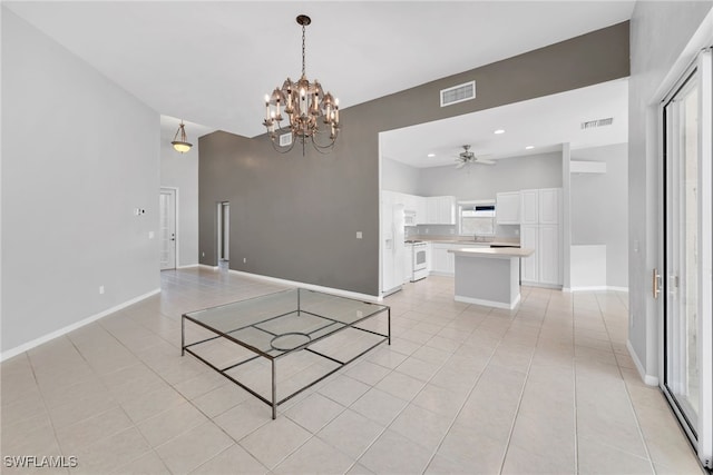 interior space with ceiling fan with notable chandelier and light tile patterned floors