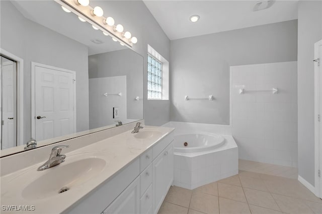 bathroom with tile patterned floors, vanity, lofted ceiling, and tiled tub