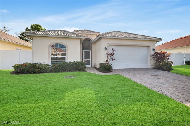 view of front of property featuring a front lawn and a garage