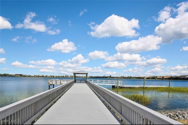 view of dock with a gazebo and a water view