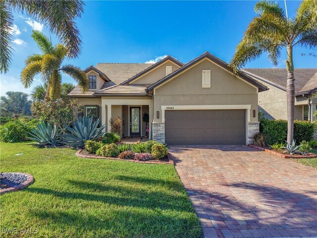 view of front of property with a front yard and a garage