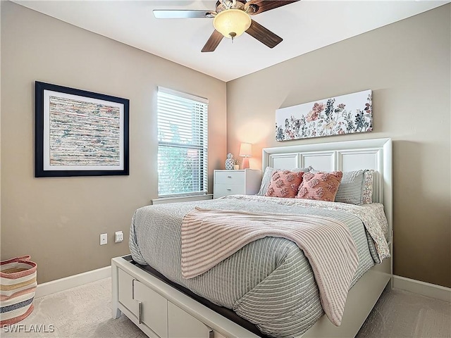 bedroom featuring ceiling fan and light carpet