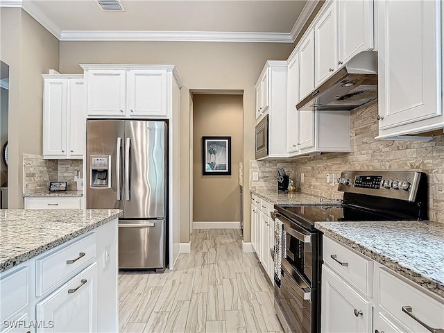 20462 Misty Woods Ct, Estero, FL 33928 - kitchen with stainless steel appliances, under cabinet range hood, white cabinets, ornamental molding, and backsplash