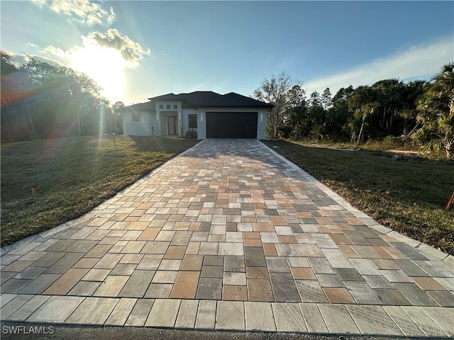 view of front of home with a front lawn and a garage