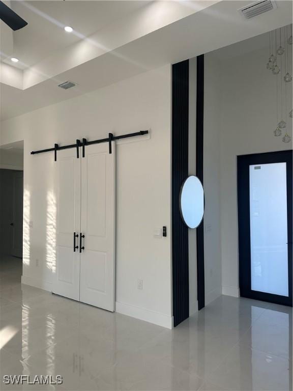 unfurnished room with a barn door