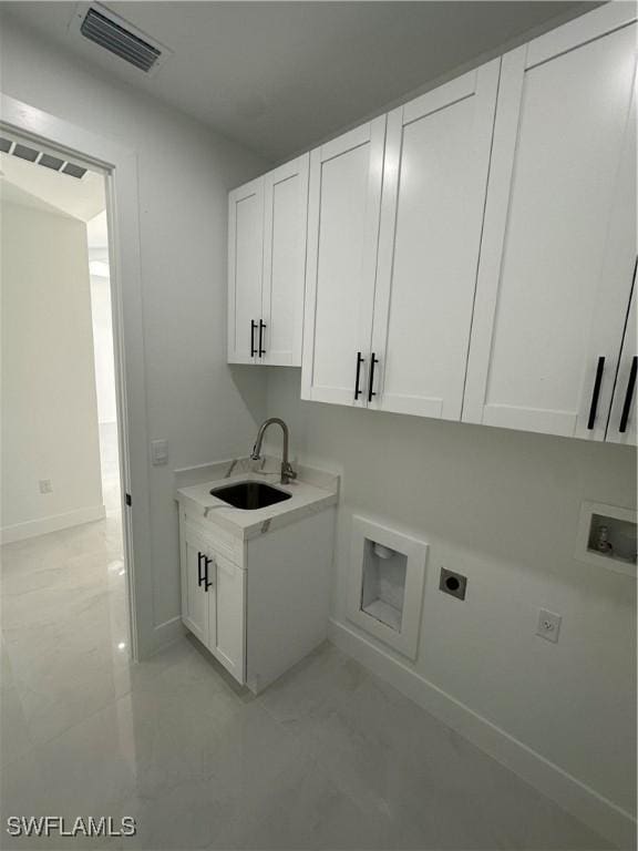 laundry room with cabinets, hookup for a washing machine, electric dryer hookup, and sink