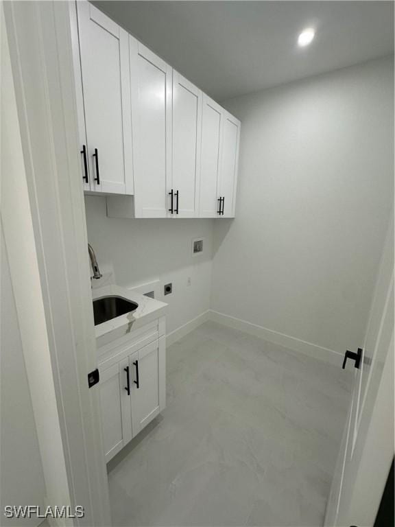 clothes washing area with cabinets, washer hookup, hookup for an electric dryer, and sink