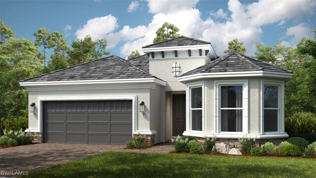 view of front facade with a garage and a front lawn