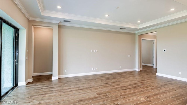 empty room with a tray ceiling and crown molding