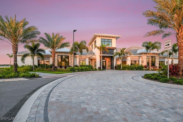 view of outdoor building at dusk