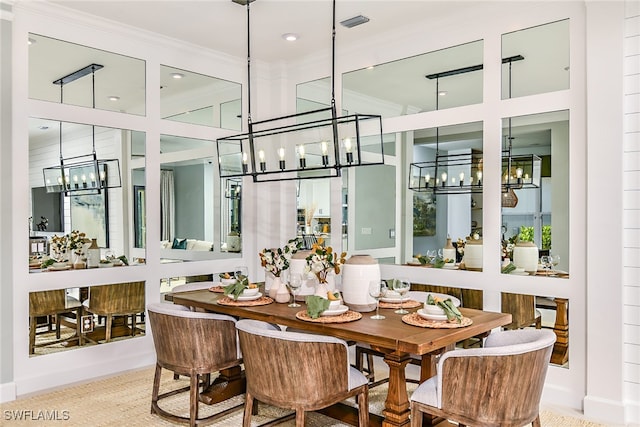 dining room with ornamental molding and a notable chandelier