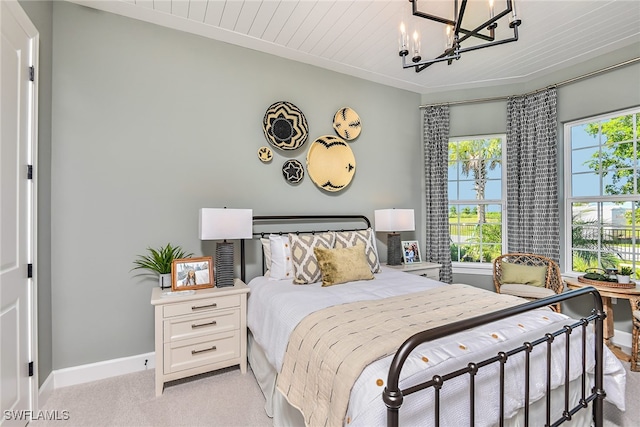 carpeted bedroom featuring a chandelier and wood ceiling