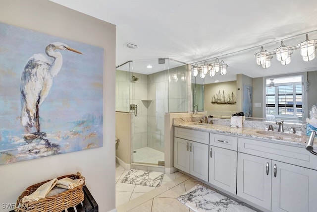 bathroom featuring tile patterned floors, vanity, and an enclosed shower