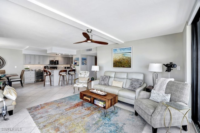 tiled living room with beamed ceiling, wine cooler, and ceiling fan