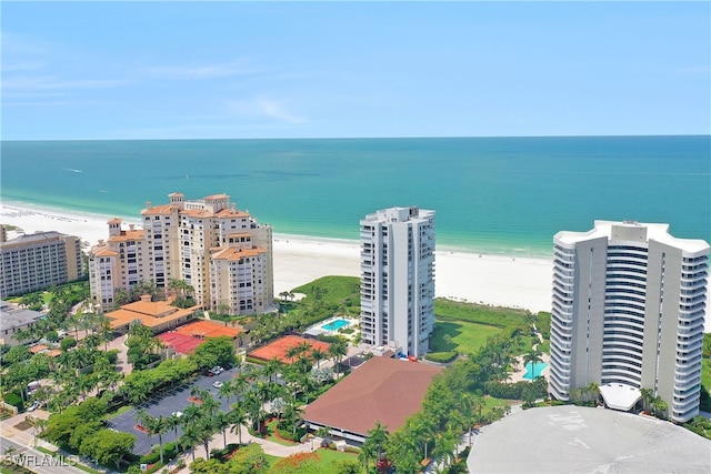 drone / aerial view with a water view and a beach view