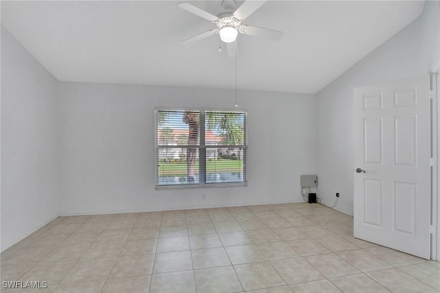 tiled spare room featuring vaulted ceiling and ceiling fan