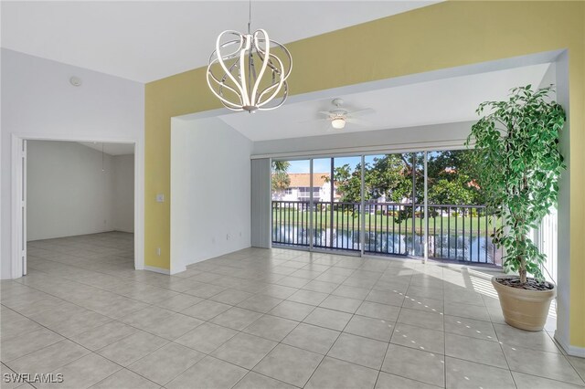 spare room with a water view, ceiling fan with notable chandelier, and light tile patterned floors