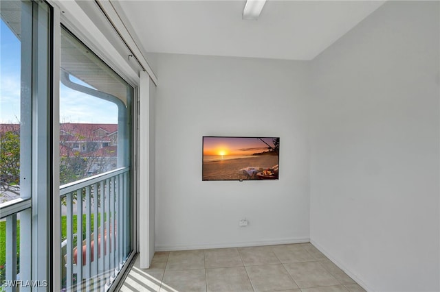 interior space featuring light tile patterned floors and baseboards