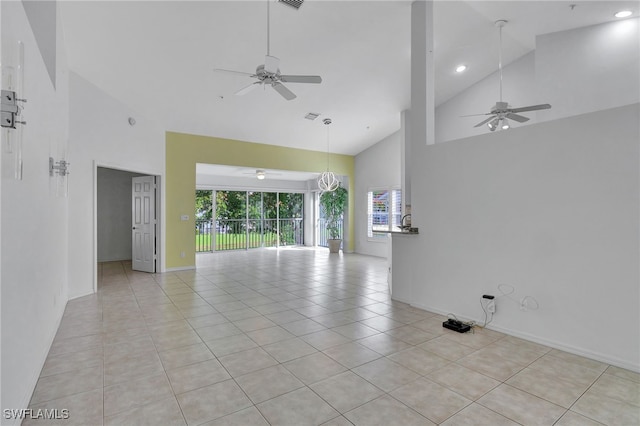 tiled spare room featuring high vaulted ceiling and ceiling fan