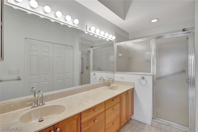 bathroom with vanity, an enclosed shower, and tile patterned floors